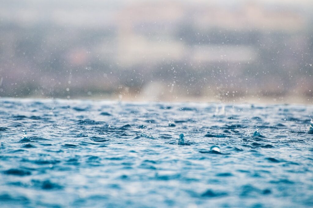 Rain falling into a lake.