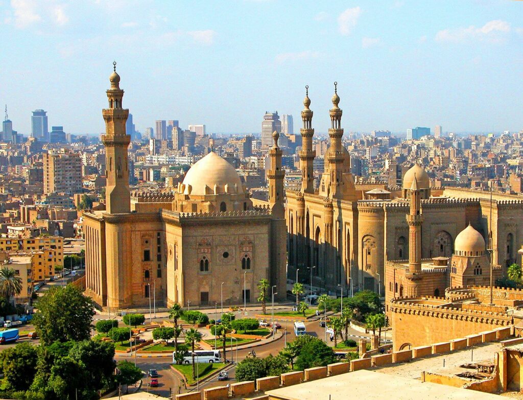 A mosque overlooks a large city.