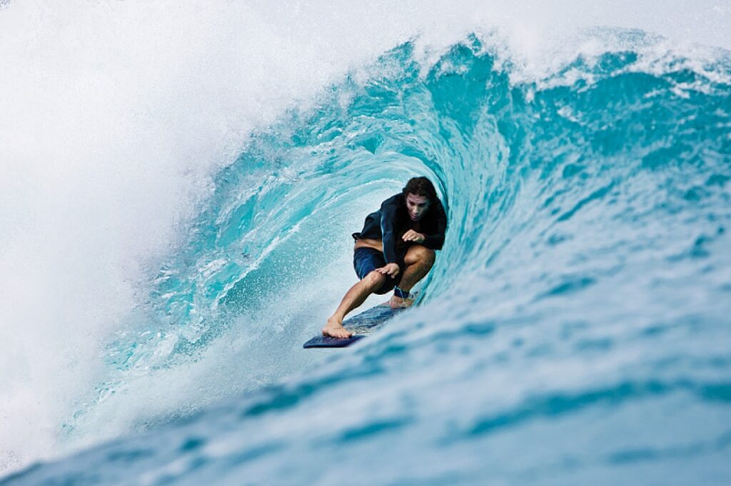 Surfer under wave