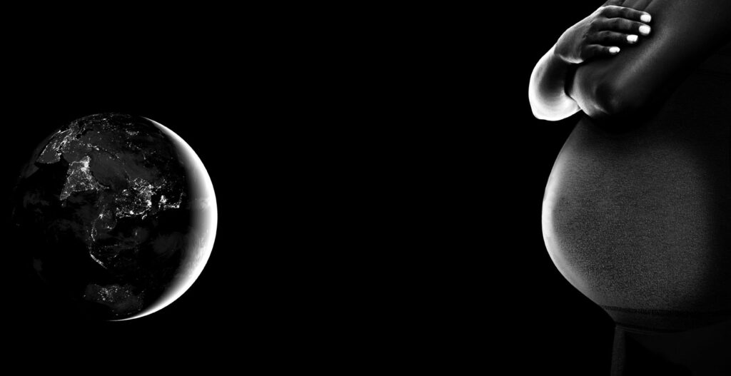 The Earth pictured beside a pregnant woman's stomach