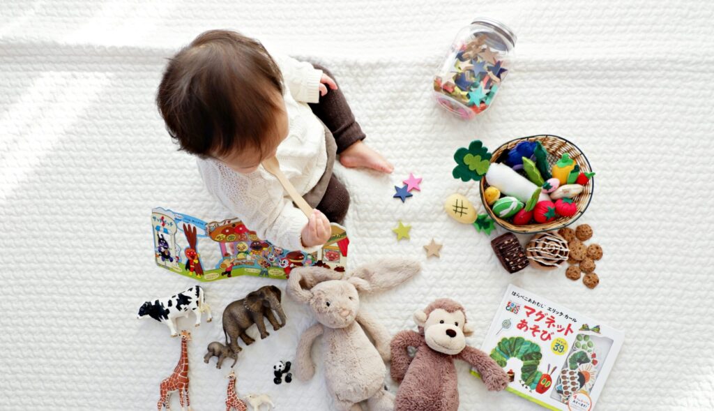 A baby playing with toys on a blanket