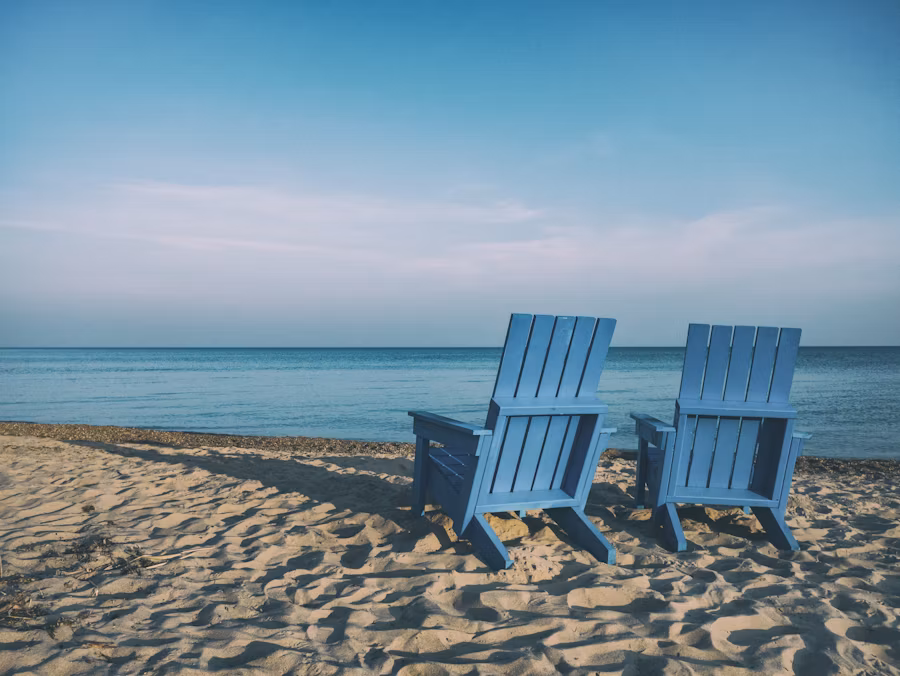 Two beach chairs by the ocean on the beach