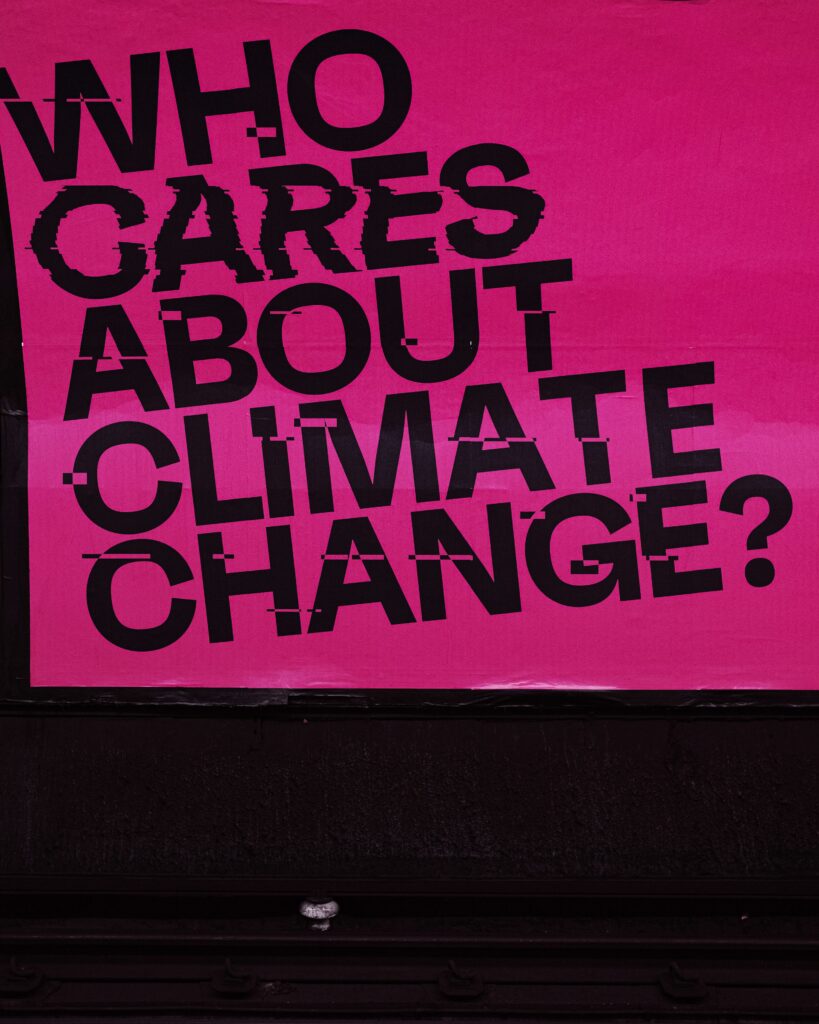 Pink sign reading: Who cares about climate change?
